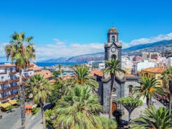 Photo of aerial view with Puerto de la Cruz, in background Teide volcano, Tenerife island, Spain.