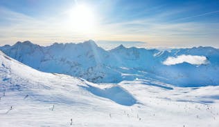 Photo of aerial view of beautiful winter landscape of Les Deux Alpes surrounded by mountains, France.