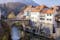 Photo of Capuchin Bridge in Skofja Loka over Selska Sora river, medieval town in Slovenia in autumn time.