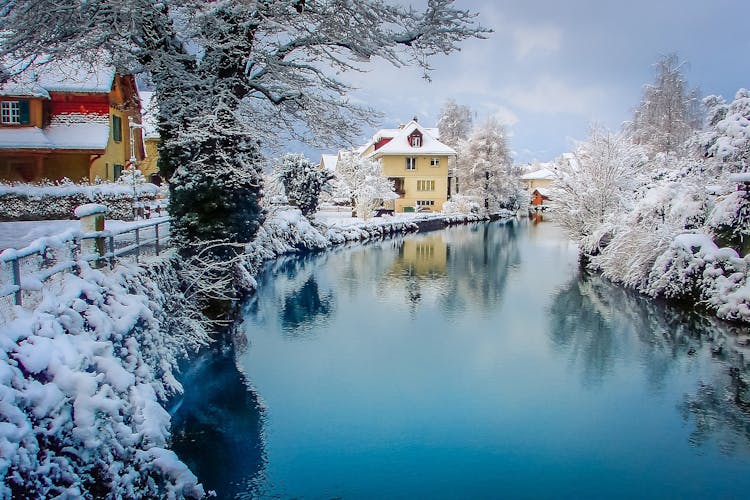 Photo of Interlaken idyllic landscape after snow in winter with river reflection, Swiss alps, Switzerland .