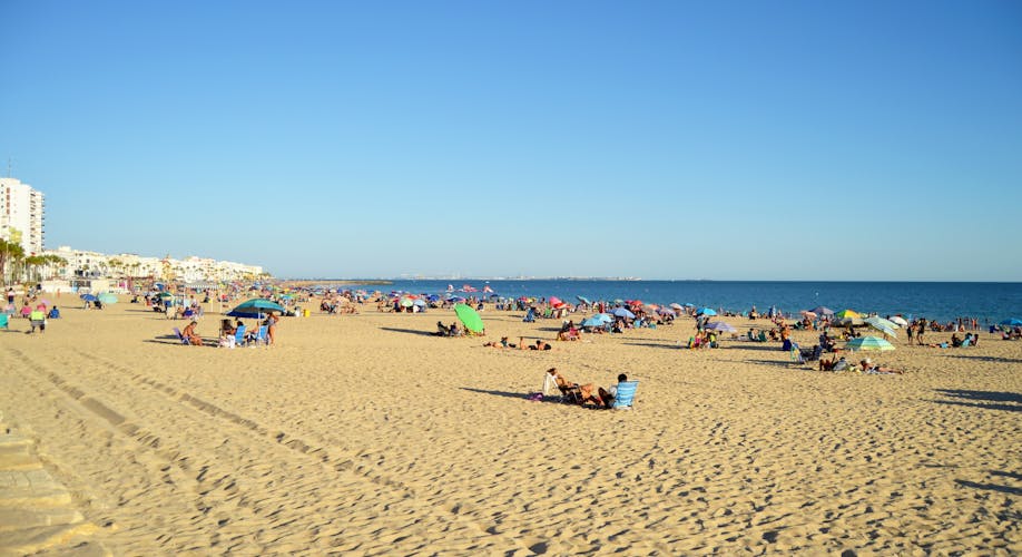 Tourism in spain. People at beach in Rota, Cadiz, Spain.