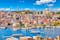 Touristic sightseeing ships in Golden Horn bay of Istanbul and mosque with Sultanahmet district against blue sky and clouds. Istanbul, Turkey during sunny summer day.