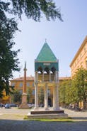 Photo of Italy Piazza Maggiore in Bologna old town tower of town hall with big clock and blue sky on background, antique buildings terracotta galleries.