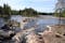 Photo of beautiful river scenery with cliffs, forest and rapids in Koitelinkoski in Oulu, Finland.