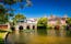 Photo of a stone bridge spans the River Avon, Christchurch, Dorset, England on a hot summer day.