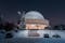 Silesian Planetarium during the blue hour. Beautiful winter scenery. The snow-covered dome of the observatory