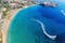 Photo of aerial panoramic beautiful view of Coral bay beach with jet ski and people having fun, Cyprus.