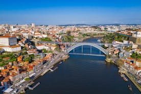 Porto, Portugal old town ribeira aerial promenade view with colorful houses, Douro river and boats.