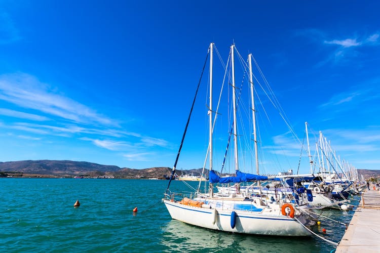 Photo of sailing ships and yachts stand moored in the port of Volos, Greece.