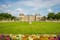 Photo of Luxembourg gardens and palace with puffy clouds in Paris, France.