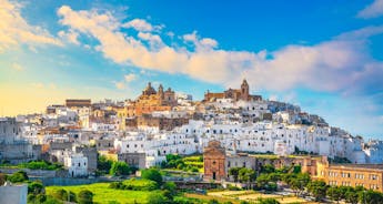 Photo of panoramic view of the ancient town of Matera (Sassi di Matera), European Capital of Culture 2019, in beautiful golden morning light with blue sky and clouds, Basilicata, southern Italy.