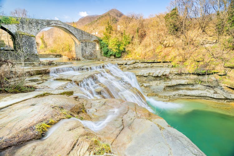 Photo of Brusia waterfalls and Bridge in mountains of Forlì.