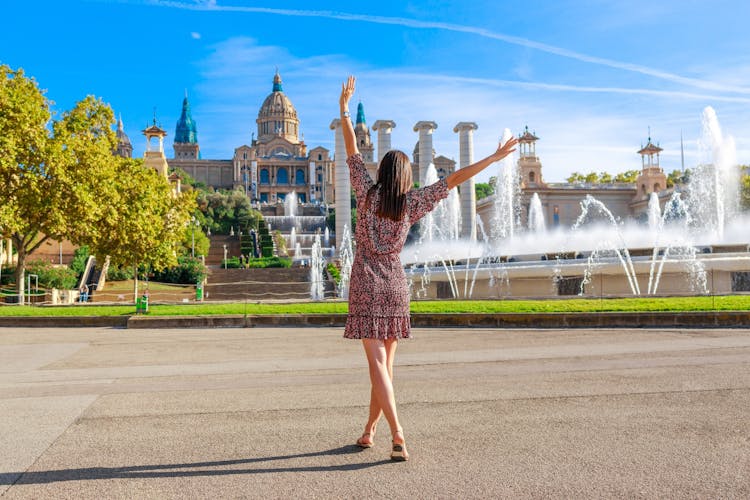 Photo of tourist woman on Montjuic hill. Populal sight in Barcelona, Spain.