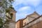 photo of Side View with the Bell Tower of the Basilica of San Clemente in the Center of Rome on a Background of Partly Cloudy Sky,Rome Italy.