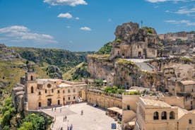 Photo of panoramic view of the ancient town of Matera (Sassi di Matera), European Capital of Culture 2019, in beautiful golden morning light with blue sky and clouds, Basilicata, southern Italy.