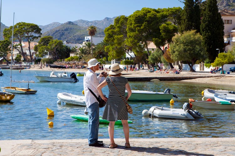 People enjoy sunny day out in Port de Pollenca.