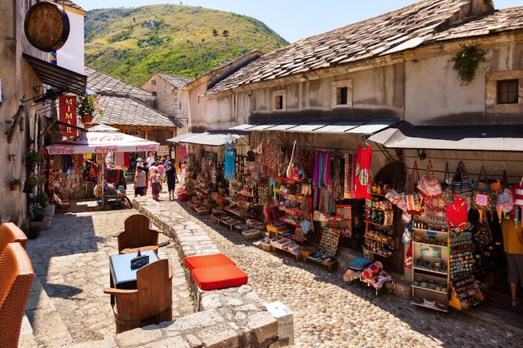 People walking through the Old Town with many shops and cafes in Mostar, Bosnia and Herzegovina. Mostar is situated on the Neretva River.