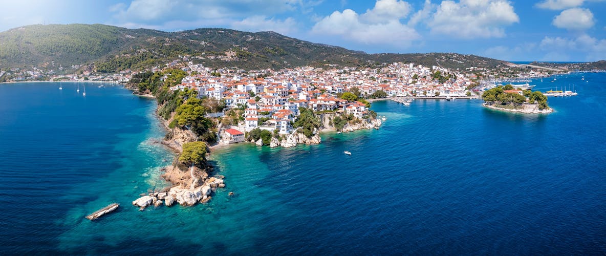 Photo of panoramic view to the harbor and town of Skiathos island.