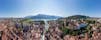 photo of Annecy city center panoramic aerial view with the old town, castle, Thiou river and mountains surrounding the lake, beautiful summer vacation tourism destination in France, Europe.
