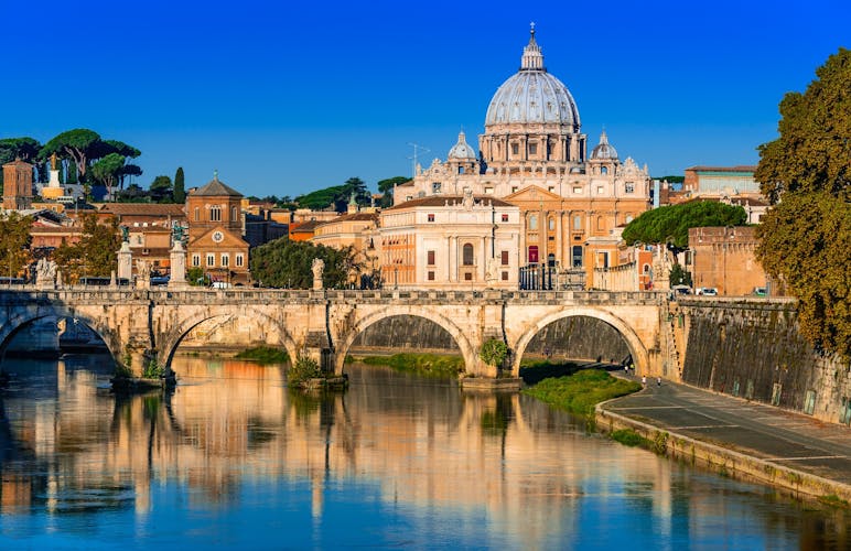  Vatican dome of San Pietro and Sant Angelo Bridge, over Tiber river in Rome, Italy.