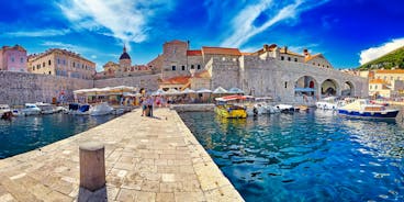 Photo of panorama and landscape of Makarska resort and its harbour with boats and blue sea water, Croatia.