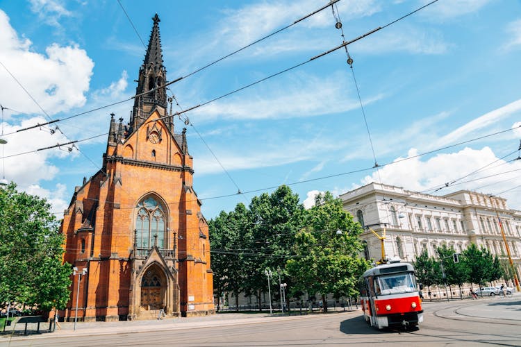 Photo of Old town street, The Church of Jan Amos Comenius Red Church and tram in Brno.