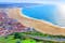 Photo of wonderful romantic afternoon aerial landscape coastline of Nazare beach riviera (Praia da Nazare) with cityscape of Nazare town ,Portugal.