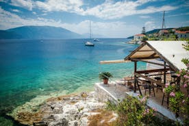 Photo of white boat in crystal clear blue sea water, Argostoli, Greece.