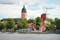 photo of panoramic cityscape from a sailing boat. Yacht marina, cathedral, traditional houses, windmill. Strängnäs, Mälaren lake, Sweden.