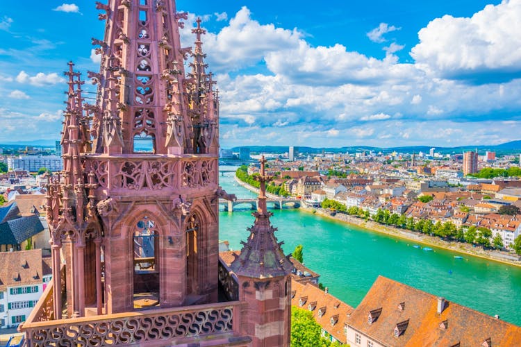 Photo of Riverside of Rhine in Basel dominated by majestic building of Munster church, Switzerland