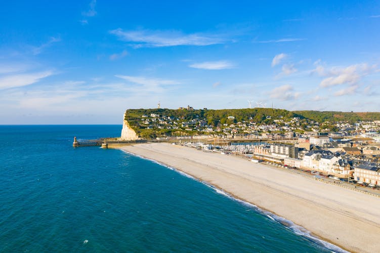 This photo was taken in France, north of Normandy, in Fécamp with a drone. We can see Cap Fagnet, the port and the beach of the city located in the background.