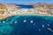 Photo of aerial view to the popular bay of Ornos on the island of Mykonos, Greece.
