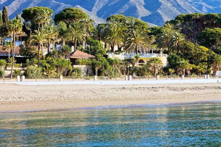 Marbella sandy beach coastline summer holiday scenery by the Mediterranean Sea in Spain, Andalusia region, Costa del Sol, Malaga province.