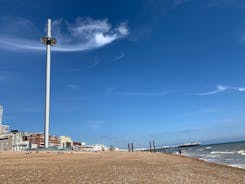 Photo of panoramic view along Brighton Beachfront with the promenade and Ferris Wheel backed by highrise buildings, UK.
