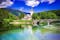 Bohinj Lake, Slovenia. Church of St John the Baptist with bridge over Sava River. Triglav National Park in Julian Alps.