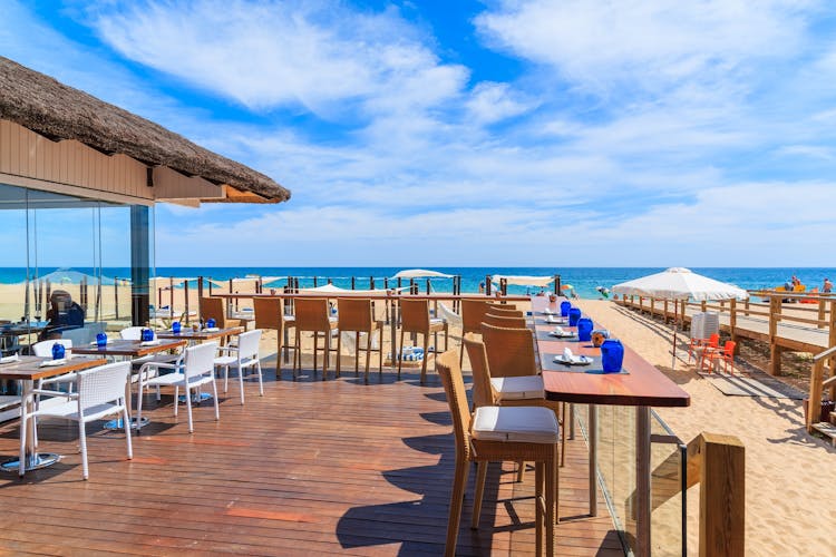 Photo of terrace of a restaurant on Armacao de Pera beach in Algarve region, Portugal.