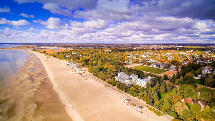 Photo of aerial view of the beautiful seaside city of Parnu, Estonia. Seen also the clouds from the sky and the coastal beach in the side