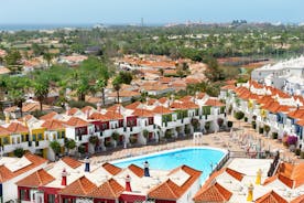 photo of landscape with Maspalomas town and golden sand dunes at sunrise, Gran Canaria, Canary Islands, Spain.