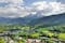 photo of Elevated, scenic view of the town of Bischofswiesen, Bavaria, Germany. The Watzmann Mountain, part of the Bavarian Alps rises into a majestic skyline. A green, spring landscape set in the valley.