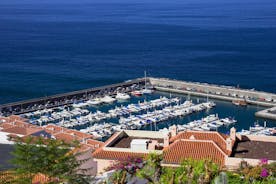 photo of aerial shot of Costa Adeje area, South Tenerife, Spain. Captured at golden hour, warm and vivid sunset colors. Luxury hotels, villas and restaurants behind the beach.