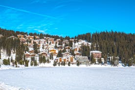 photo of beautiful snow capped mountains with Arosa village in France. Back country skier in the foreground leave their tracks in the deep snow.