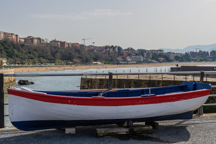 White rowing boat and in the background the beach of Ereaga in the municipality of Getxo.