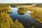 Photo of aerial view of a pond and taiga forest in Tiilikkajärvi National Park, Finland.