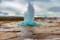 photo of the great geysir erupting in spring, Iceland.