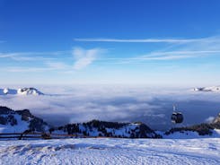 Photo of Dornbirn at sunset with a view of the meadows, forests and snowy mountains in background, Austria.