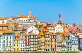 Porto, Portugal old town ribeira aerial promenade view with colorful houses, Douro river and boats.