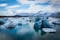 photo of big pieces of ice (floe) from glacier in the lake, ice islands, glacier and mountains, Jökulsárlón - Glacier lagoon.