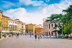 Photo of aerial view of Verona historical city centre, Ponte Pietra bridge across Adige river, Verona Cathedral, Duomo di Verona, red tiled roofs, Veneto Region, Italy.