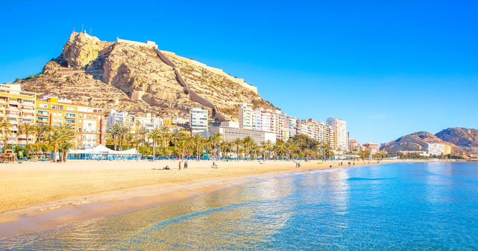 Photo of postiguet beach and coastline in Alicante resort town, Spain.