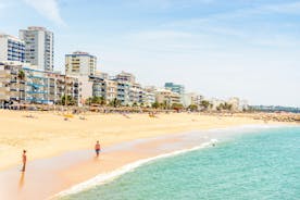 Photo of wide sandy beach in white city of Albufeira, Algarve, Portugal.